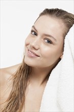 Portrait of young woman with wet hair and towel. 
Photo : Jan Scherders