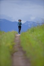 USA, Montana, Whitefish, Woman jogging on mountain path. 
Photo : Noah Clayton