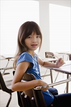 Portrait of schoolgirl holding pencil. 
Photo: Rob Lewine