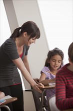 Teacher helping schoolchildren (6-7). 
Photo: Rob Lewine