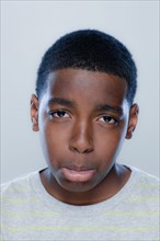 Portrait of teenage boy (14-15), studio shot. 
Photo: Rob Lewine
