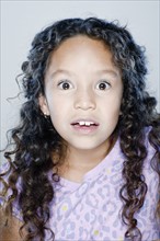 Portrait of surprised girl (8-9), studio shot. 
Photo: Rob Lewine