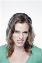 Portrait of angry young woman, studio shot. 
Photo: Rob Lewine