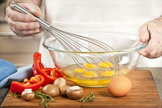 Chef preparing omelet. 
Photo: Elena Elisseeva