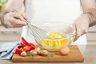 Chef preparing omelet. 
Photo : Elena Elisseeva