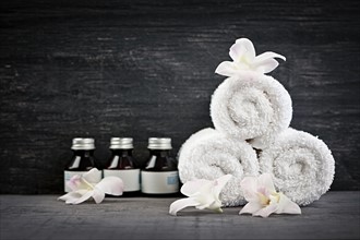 Still life with bottles, flowers and towels. 
Photo : Elena Elisseeva