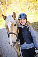 Portrait of teenage girl (16-17) with horse. 
Photo: Elena Elisseeva