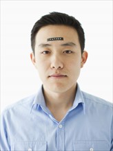 Portrait of young man with word 'father' on forehead, studio shot. 
Photo: Jessica Peterson