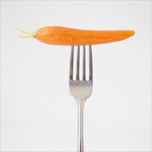 Carrot on fork, studio shot. 
Photo: Jessica Peterson
