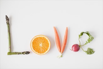 Word 'love' made out of fruits and vegetables, studio shot. 
Photo : Jessica Peterson