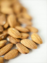 Close-up of almonds on plate, studio shot. 
Photo: Jessica Peterson