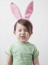 Portrait of mixed-race girl (2-3) wearing bunny ears. 
Photo: Jessica Peterson