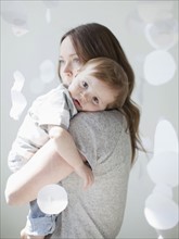 Portrait of serene young woman embracing baby boy (6-11 months). 
Photo : Jessica Peterson