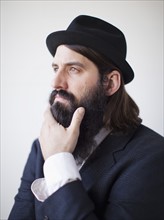 Portrait of contemplative bearded young man. 
Photo : Jessica Peterson