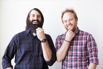 Two bearded males posing together with hands on chins. 
Photo : Jessica Peterson