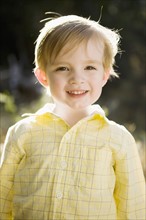 Outdoor portrait of happy young boy (6-7) . 
Photo: Jessica Peterson