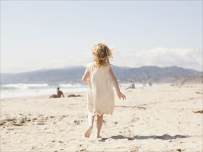 USA, California, Los Angeles, Happy young girl (4-5) running on beach. 
Photo : Jessica Peterson