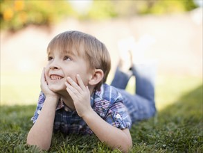 Outdoor portrait of happy young boy (6-7) . 
Photo: Jessica Peterson