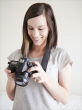 Young woman playing with digital camera. 
Photo: Jessica Peterson