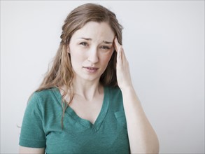 Studio shot of young suffering from headache. 
Photo: Jessica Peterson