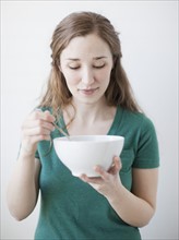 Happy young woman enjoying bowl of cornflakes. 
Photo : Jessica Peterson