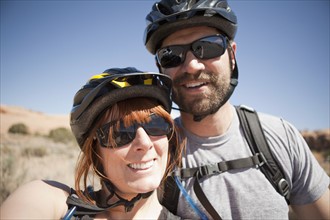 Outdoors portrait of couple in cycling gear. 
Photo : Jessica Peterson
