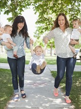 USA, Utah, Salt Lake City, Two young mothers walking with two baby boys (6-11 months) and toddler