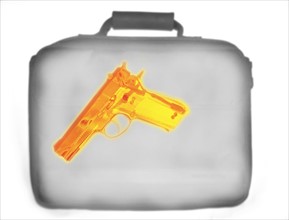 X-ray image showing handbag containing pistol. 
Photo : Calysta Images