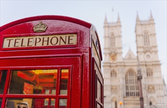 UK, London, Phone booth with Westminster Abbey behind.