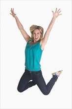 Woman jumping on white background.