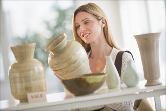 Woman buying pottery.