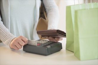 Woman paying with credit card.