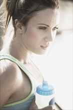 Athletic woman with water bottle.