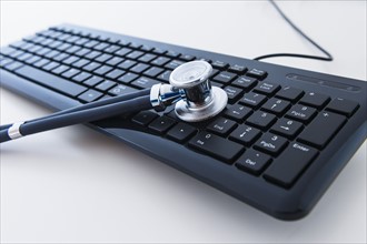 Stethoscope on computer keyboard.