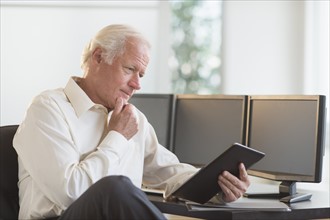 Senior man using tablet pc.