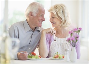 Couple enjoying healthy meal in restaurant.