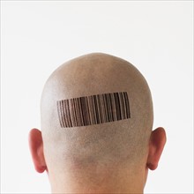 Back view of man with bar code on head.