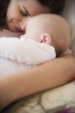 Mother and baby boy (2-5 months) sleeping together . Photo : Jamie Grill