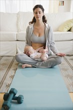 Mother and baby boy (2-5 months) practicing yoga. Photo: Jamie Grill