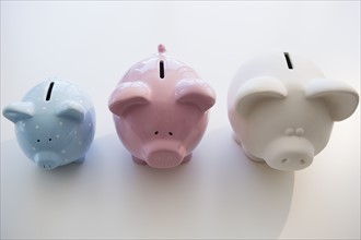 Three piggy banks in arranged order of magnitude. Photo: Jamie Grill