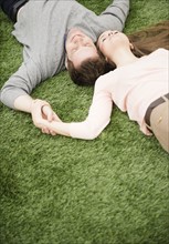 Couple relaxing on grass. Photo : Jamie Grill