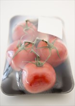 Tomatos in packaging. Photo : Jamie Grill