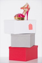 Studio shot of dress shoe on top of stack of boxes. Photo: Daniel Grill