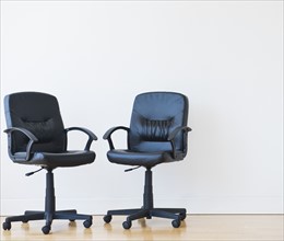 Studio shot of two black office chairs. Photo: Daniel Grill