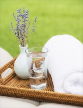 Wattle tray with glass of water, towel and lavender. Photo : Daniel Grill