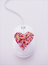Colorful heart on computer mouse. Photo: Daniel Grill