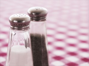 Salt and pepper shakers on checked tablecloth. Photo: Daniel Grill