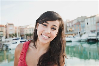 France, Cassis, Portrait of young smiling woman. Photo : Mike Kemp