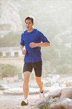 France, Marseille, Man jogging on sunny day. Photo: Mike Kemp
