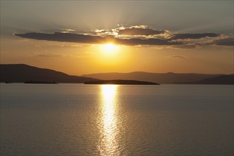 USA, Montana, Flathead Lake, View of sunset over lake. Photo: Noah Clayton
